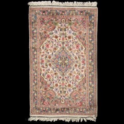 Tapis à fond crème à décor d’un médaillon...
