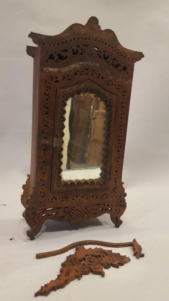Wooden doll's cupboard with openwork decoration....