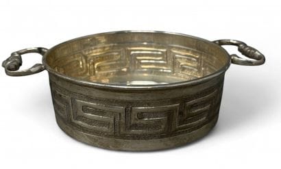 Metal bowl with two handles decorated with...