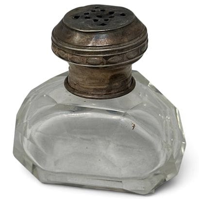 Salt shaker made of cut glass with a silver...