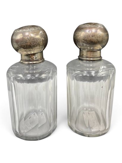 Pair of cylindrical glass bottles with beveled...