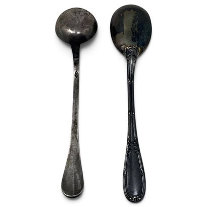 A small mustard spoon and a small silver...
