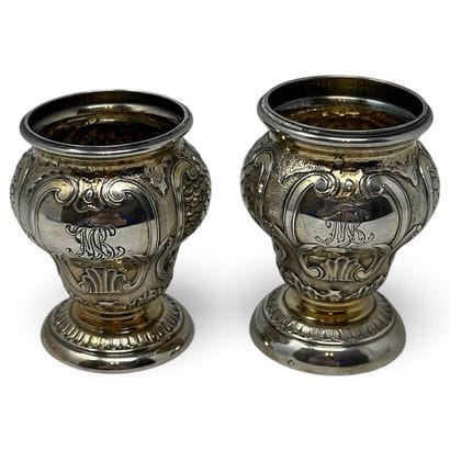 Two small silver vases decorated with scales...