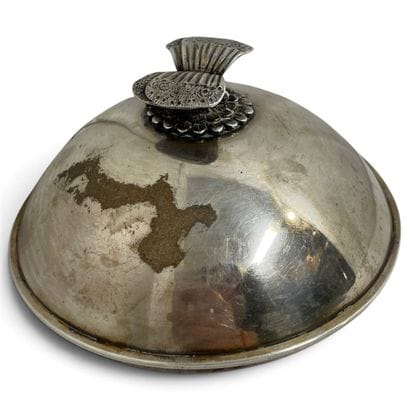 Silver lid with a butterfly-shaped handle.
Unofficial...
