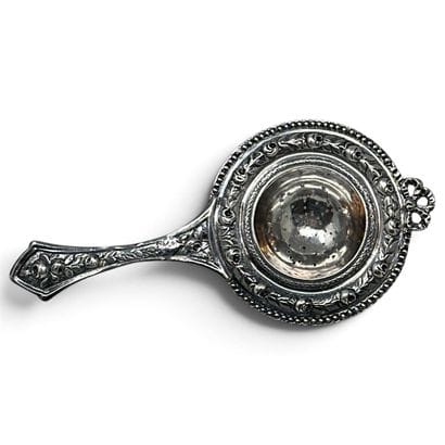Silver (800) tea strainer with chased and...