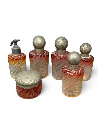 Pink-tinted molded glass toiletry set decorated...