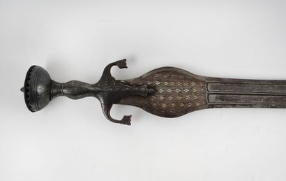 Persian sword. Iron mount nielloed of silver.

Half...