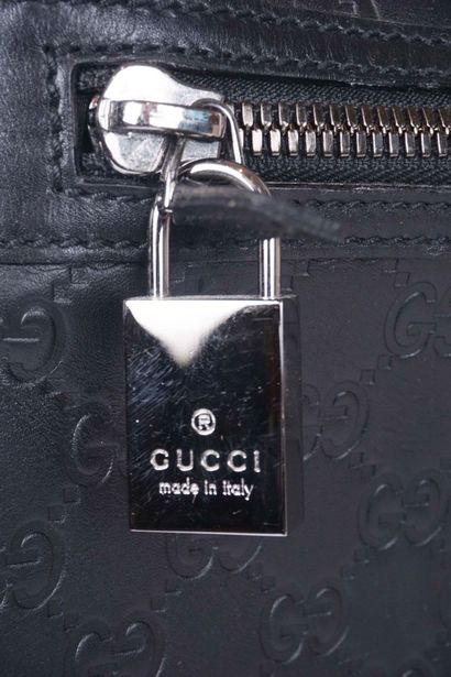 GUCCI
Gucci monogram leather rolling suitcase...