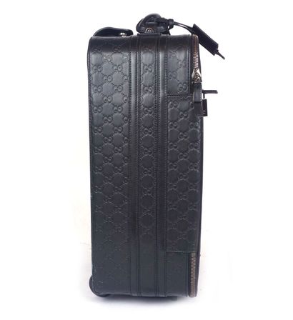 GUCCI
Gucci monogram leather rolling suitcase...