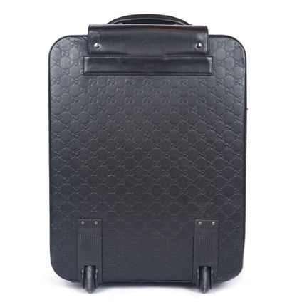 GUCCI
Gucci monogram leather rolling suitcase...