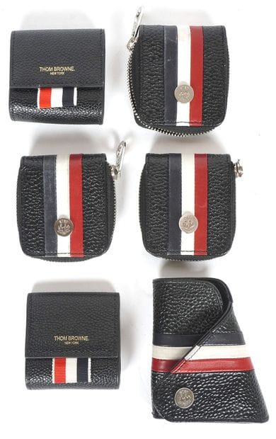 THOM BROWNE
5 petits porte-monnaie et un...