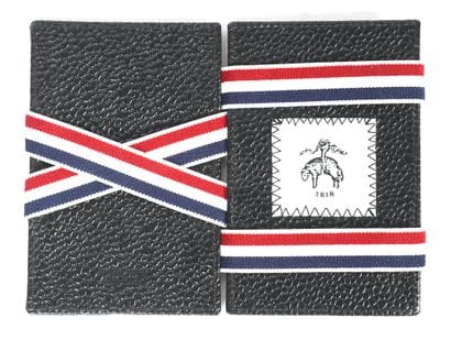 THOM BROWNE
Petit porte-monnaie en cuir noir...