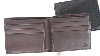 GUCCI 
Deux porte-monnaie Gucci en cuir marron...