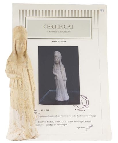 TANG DYNASTY

Terracotta statuette depicting...
