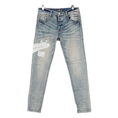 AMIRI
Jean bleu en denim délavé avec écusson...
