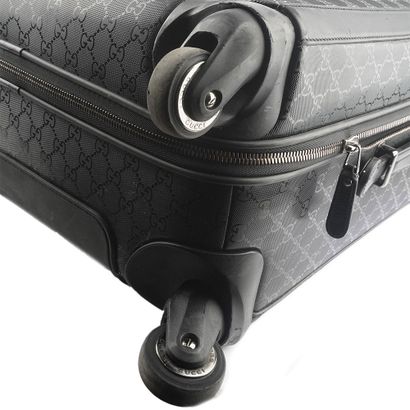 GUCCI
Gucci Monogram canvas rolling suitcase...