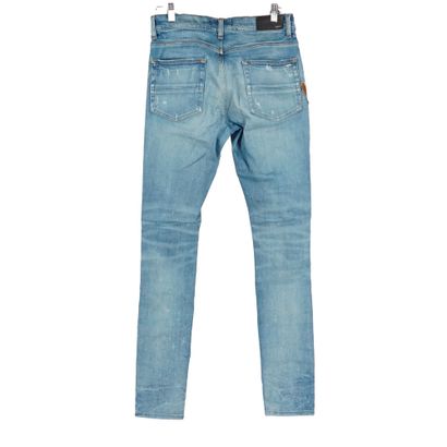 AMIRI 
Jean bleu coupe skinny en denim élastique....