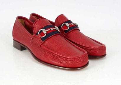 GUCCI 
Red leather penny loafers featuring...