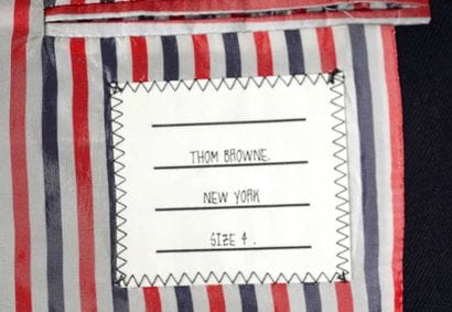 THOM BROWNE
Navy blue tailored jacket fastened...