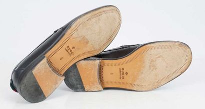 GUCCI
Black leather penny loafers.
Men's...
