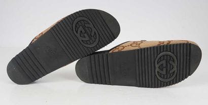 GUCCI
Brown canvas mules featuring the GG...