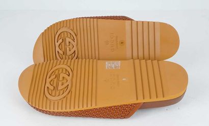 GUCCI
Brown braided leather mules featuring...