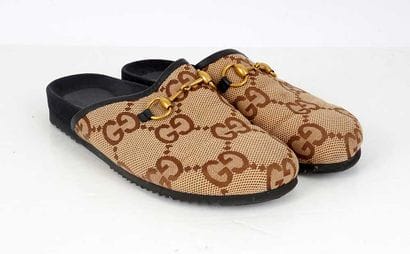 GUCCI
Brown canvas mules featuring the GG...