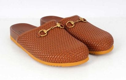 GUCCI
Brown braided leather mules featuring...