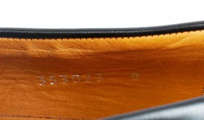 GUCCI 
Black leather loafers with a tasseled...
