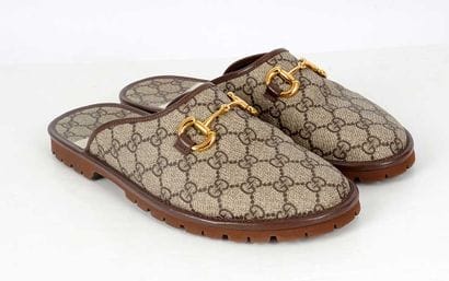 GUCCI
Brown canvas mules featuring the GG...
