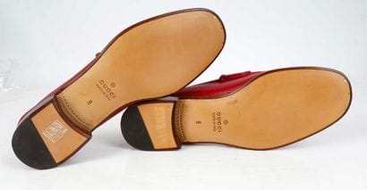GUCCI 
Red leather penny loafers featuring...