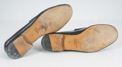 GUCCI
Gray patent leather loafers featuring...