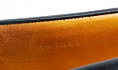 GUCCI
Black leather penny loafers.
Men's...