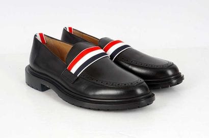 THOM BROWNE
Black leather loafers with perforated...