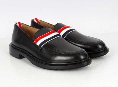 THOM BROWNE
Black leather loafers with perforated...