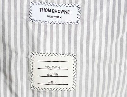 THOM BROWNE 
Dark blue quilted cashmere blazer...