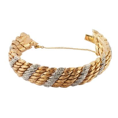 FANTAISIE
Bracelet large en métal doré et...