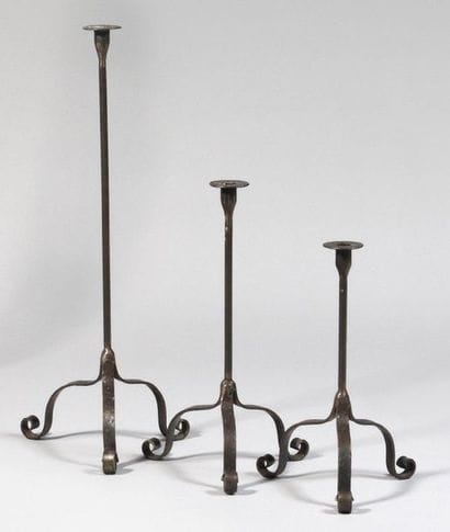 Suite of three wrought iron tripod candleholders...