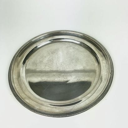 Round flat silver plate with beaded edge....