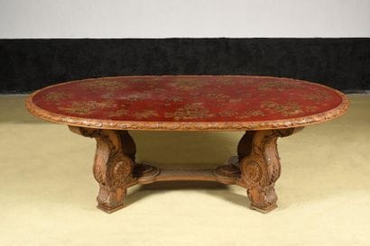 Large dining room table in richly carved...