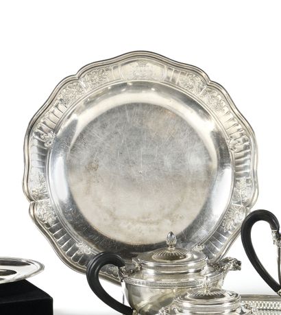 Round silver plate with contoured edges carved...