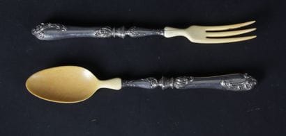 Filled silver salad servers with foliage...