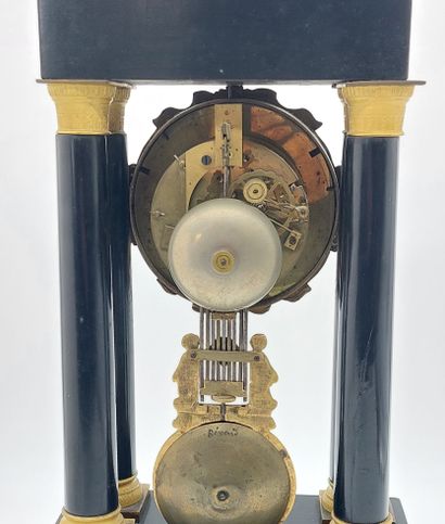 PENDULE with four columns in blackened wood...