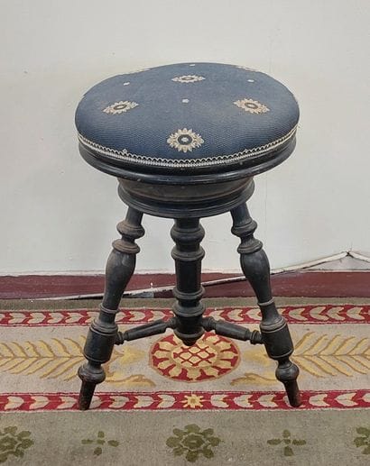 PIANO TABOURET in blackened wood, seat upholstered...