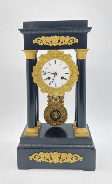 PENDULE with four columns in blackened wood...