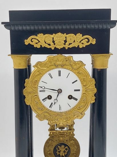 PENDULE with four columns in blackened wood...