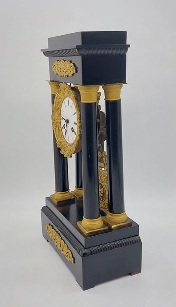 PENDULE with four columns in blackened wood...