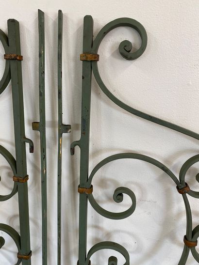 PAIR OF GREEN PAINTED WROUGHT IRON GRATES

With...