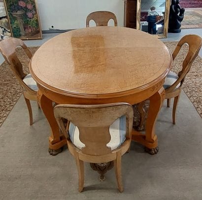 Oval dining room table with light wood struts...