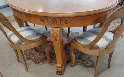 Oval dining room table with light wood struts...